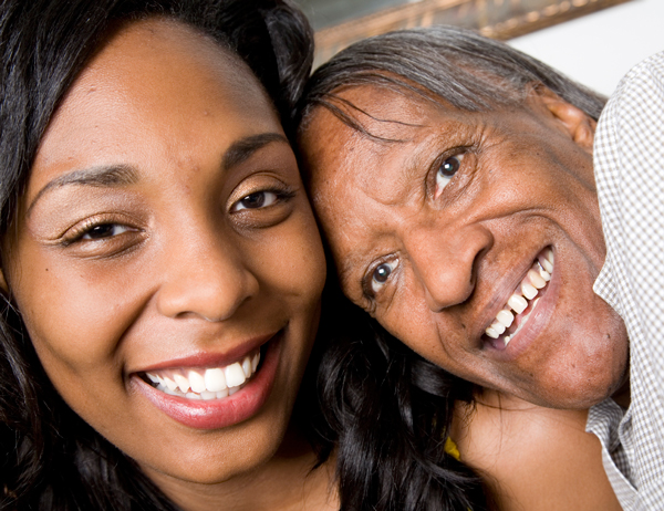Two African American woman, one with intellectual disability smiling.